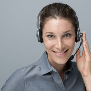 Call center and customer support operator Smiling beautiful woman with headset: call center and customer support operator